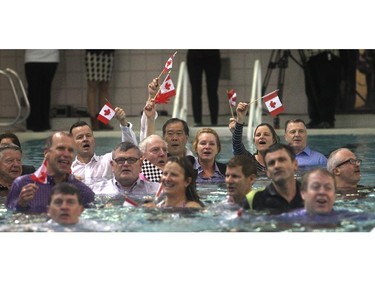 A group of Calgarians  jumped into the pool fully clothed in  at the end of Jim Gray's final lap at in his 23-year, 300,000 plus length, swimming marathon at the Eau Claire YMCA pool Friday February 27, 2015. The Eau Claire Y is to be named the Gray Family Eau Claire YMCA in his honour.