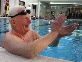 Philanthropist Jim Gray acknowledges the crowd at the end of his final lap at of his 23-year, 300,000 plus length, swimming marathon at the Eau Claire YMCA pool Friday February 27, 2015. The Eau Claire Y is to be named the Gray Family Eau Claire YMCA in his honour.