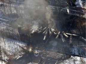 A derailed oil train smoulders in West Virginia. Reader says oil shouldn't be shipped by rail.