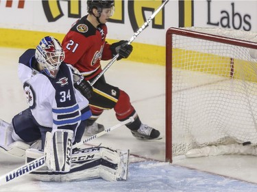 Calgary Flames Mason Raymond sneaks one in on Winnipeg Jets' goalie, Michael Hutchinson, to give the Flames a one goal lead in the second at the Saddledome in Calgary, on February 2, 2015.