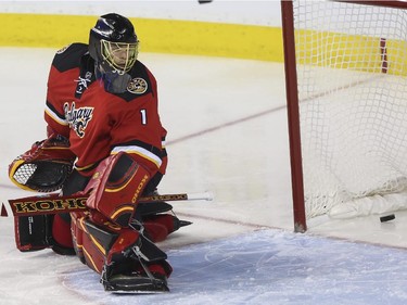 Calgary Flames goalie Jonas Hiller lets this one get by during game action against the Winnipeg Jets at the Saddledome in Calgary, on February 2, 2015.