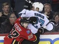 Calgary Flames forward Paul Byron checks San Jose Sharks defenceman Scott Hannan during Wednesday's game.