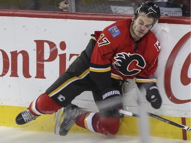 Calgary Flames' Lance Bouma hits the boards hard after racing for the open San Jose net with the puck during NHL action at the Saddledome in Calgary, on February 4, 2015. Flames finished the game up 3-1.