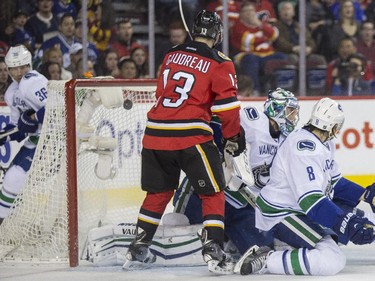 Calgary Flames' Johnny Gaudreau watches the puck hit the back of the net as Sean Monahan dumps in his second goal  against the Vancouver Canucks at the Saddledome in Calgary, on February 14, 2015.