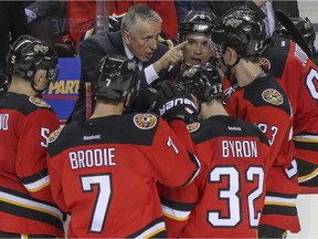Calgary Flames head coach Bob Hartley gives his team instructions during a time-out in the third period against the Vancouver Canucks game action at the Saddledome in Calgary, on February 14, 2015.