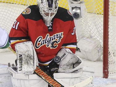 Calgary Flames goalie Karri Ramo, makes a save during the dying minutes of the third period to keep his team up 3-2 against the Vancouver Canucks at the Saddledome in Calgary, on February 14, 2015.