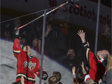 Jiri Hudler is awarded third star of the game and gives his stick to a young fan after the Calgary Flames beat the Vancouver Canucks 3-2 at the Saddledome in Calgary, on February 14, 2015.