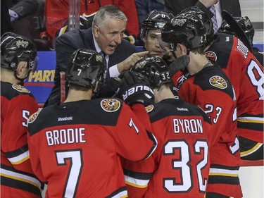 Calgary Flames head coach Bob Hartley gives his team instructions during a time-out in the third period against the Vancouver Canucks game action at the Saddledome in Calgary, on February 14, 2015.