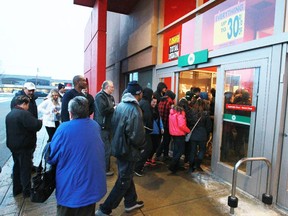 Shoppers pour into the Forest Lawn Target store as the doors opened on the first day of the company's nation-wide liquidation sale.