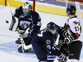 Saskatoon Blades goaltender Nik Amundrud stops this Calgary Hitmen scoring chance during third period WHL action at the Scotiabank Saddledome on Friday February 13, 2015.