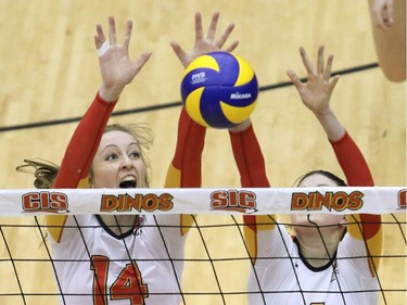 U of C Dinos Jaylynn Moffatt, left and Ali Woolley block against the UBC Thunderbirds during Canada West quarterfinal volleyball action at the Jack Simpson Gym Friday night.