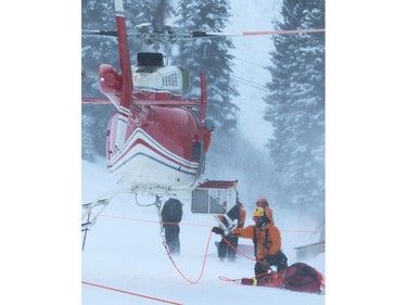 Golden and District Search and Rescue and Alpine Helicopters return gear to their staging area at Kicking Horse Mountain Resort after an avalanche outside ski resort boundaries on Tuesday Feb 3, 2015. Three people were skiing and boarding together when the avalanche caught two of them. Neither were buried but both were injured, and evacuated by helicopter.