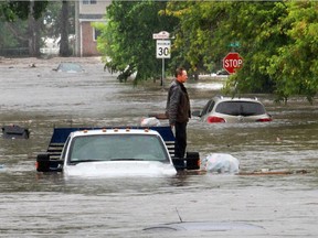 A man is trapped after his truck was submerged in flood waters on Veteran's Way in High River on June 20, 2013.