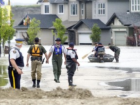 RCMP make their way through flooded High River in June 2013.
