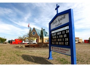 Restoration crews are seen cleaning up Holy Spirit Academy in High River in this file photo from August 14, 2013.