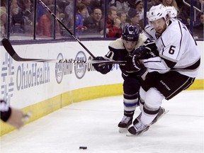 Los Angeles Kings' Jake Muzzin, right, battles Columbus' Matt Calvert during a game on Monday. The Kings are coming into Thursday's game vs. the Calgary Flames with confidence after much-needed road wins in Tampa and Columbus.