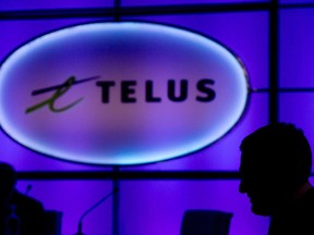 Joe Natale,  president and chief executive officer of Telus Corp., is silhouetted as he takes his seat before the telecom company's annual general meeting in Vancouver, B.C., last year.