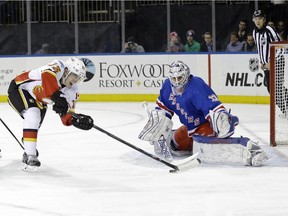 New York Rangers goalie Cam Talbot stops a shot on goal by Calgary Flames rookie Johnny Gaudreau during the first period on Tuesday night.
