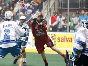 The Roughnecks' Curtis Dickson shoots against Knighthawks goaltender Matt Vinc  during the first half of the Calgary Roughnecks vs Rochester Knighthawks Champion's Cup final in Rochester N.Y. on May 31, 2014.