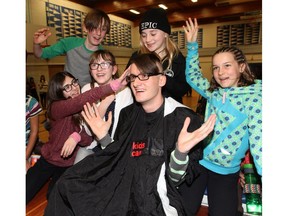 Bishop Pinkham teacher Marc Julien gets his head partially shaved during the Shave Your Lid for a Kid through Kids Cancer Care in Calgary on February 26, 2015  in honour of Edyn Drever, a former student who passed away from brain cancer last year.