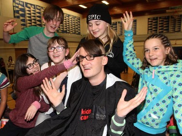 Bishop Pinkham teacher Marc Julien gets his head partially shaved during the Shave Your Lid for a Kid through Kids Cancer Care in Calgary on February 26, 2015  in honour of Edyn Drever, a former student who passed away from brain cancer last year.