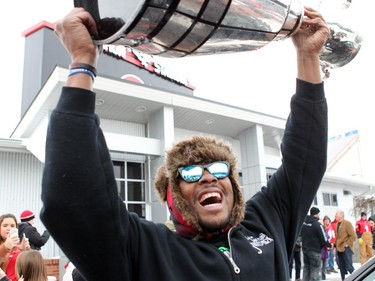 Stampeders star Nik Lewis celebrates with the 2014 Grey Cup upon returning to Calgary on Dec. 1, 2014. It was his last game in an 11-year career with the Stamps. The free agent signed with the Montreal Alouettes on Wednesday.
