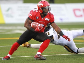 Calgary Stampeders running back Jock Sanders  dodges a tackle by Hamilton defensive end Arnaud Gascon-Nadon during a game last July.