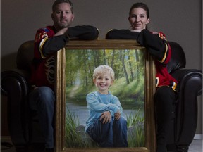 Rod and Jennifer O'Brien, parents of missing child Nathan O'Brien, with the oil painting of Nathan by John Seibels Walker. Nathan is presumed dead, along with his grandparents, and a family friend has been charged with their murder.