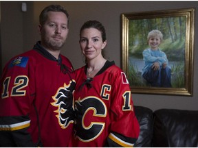 Rod and Jennifer O'Brien pose with a painting of their son, Nathan.