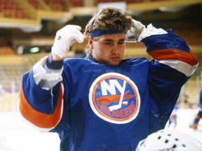 Kelly Hrudey of the New York Islanders adjusts his head band in pre-game warm up before a 1980s era game against the Boston Bruins. Now the colour commentator on Flames' Sportsnet broadcasts, Hrudey can look back fondly on the old days at the soon-to-be-vacated Nassau Coliseum in Uniondale, N.Y.