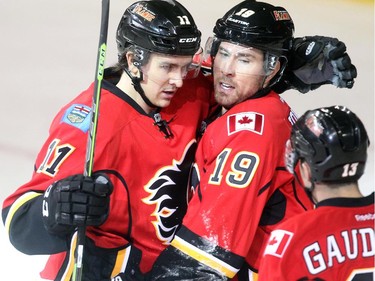 David Jones of the Calgary Flames celebrates his goal with linemates Mikael Backlund, left, and Johnny Gaudreau against the Boston Bruins at the Saddledome Monday February 16, 2015.