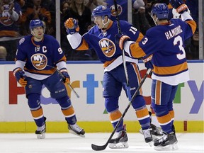 New York Islanders' Ryan Strome, centre, reacts after scoring during the first period of the NHL hockey game against the Calgary Flames, Friday, Feb. 27, 2015, in Uniondale, N.Y. The Flames lost 2-1.