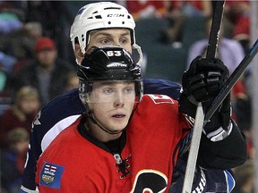 Sam Bennett, seen battling  Winnipeg Jets defenceman Mark Stuart in October, impressed Flames brass,  but they sent him back to junior because he needs time to get back up to speed from shoulder surgery.