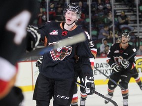 CALGARY, AB.; SEPTEMBER 26, 2014  --  Chase Lang of the Calgary Hitmen and his linemates skate to the bench after he scored to tie the game at 2-2- in the second period against the Medicine Hat Tigers Friday September 26, 2014 at the Sadledome. (Ted Rhodes/Calgary Herald) For Sports story by Lawrence Heinen. Trax 00059079A