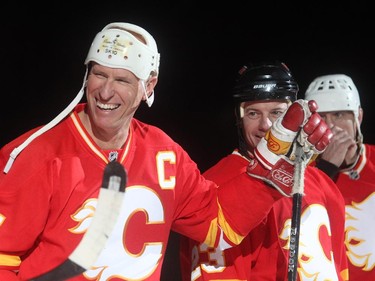 Former Calgary Flames captain Jim Peplinski, left, and current assistant coach Martin Gelinas are introduced before the start of the Nathan O'Brien Children's Foundation hockey game on Thursday February 5, 2015 at the Saddledome.