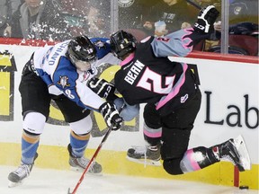 Hitmen rookie Jake Bean, seen crashing into Kootenay's Vince Loschiavo during a December game, scoring the overtime winner for Calgary on Wednesday in Portland.