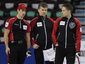 Ontario coach Bryan Cochrane, centre, chatted with team members Mat Camm, left, and David Mathers during the team practices on Friday for the Tim Hortons Brier in Calgary on February 27, 2015.