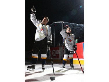 An emotional Rod O'Brien and his son Luke acknowledge the cheers before the start of the  Nathan O'Brien Children's Foundation hockey game Thursday February 5, 2015 at the Saddledome. A team made up of Nathan's family, local police and politicians took on a Calgary Flames Alumni squad.