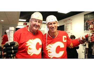 Old school helmet guys Archie Henderson and Jim Peplinski before the start of the Nathan O'Brien Children's Foundation hockey game Thursday February 5, 2015 at the Saddledome. A team made up of Nathan's family, local police and politicians took on a Calgary Flames Alumni squad.
