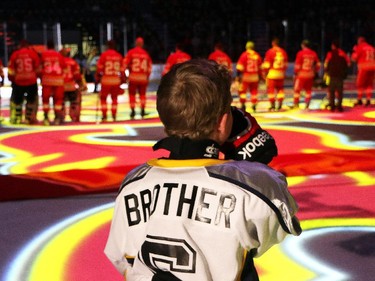 An emotional Luke O'Brien, brother of the late Nathan, listens to the national anthem before the start of the  Nathan O'Brien Children's Foundation hockey game Thursday February 5, 2015 at the Saddledome. A team made up of Nathan's family, local police and politicians took on a Calgary Flames Alumni squad.