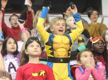 Seven year old Kieran Jordan stands up and cheers a goal by Nathan's Heros at the Nathan O'Brien Children's Foundation hockey game Thursday February 5, 2015 at the Saddledome. A team made up of Nathan's family, local police and politicians took on a Calgary Flames Alumni squad.