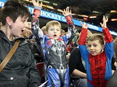 Seven year old Caleb O'Connor, left, and Maddox Rockenbach, 4, stand up and cheer on Nathan's Heros at the Nathan O'Brien Children's Foundation hockey game Thursday February 5, 2015 at the Saddledome. A team made up of Nathan's family, local police and politicians took on a Calgary Flames Alumni squad. Kids from the Holy Names school choir, grades one to six, took up the better part of a section in support of the O'Briens.