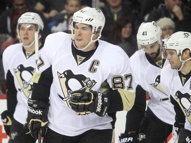 Pittsburgh Penguins captain Sidney Crosby leads his linemates, from the left, winger David Perron, defenceman Robert Bortuzzo and winger Chris Kunitz, off the ice after scoring the Penguins third goal of the game against the Calgary Flames during the second period at the Saddledome Friday February 6, 2015.