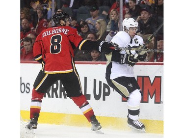 Joe Colborne of the Calgary Flames gets his stick up on Pittsburgh Penguins captain Sidney Crosby during the second period at the Saddledome Friday February 6, 2015.