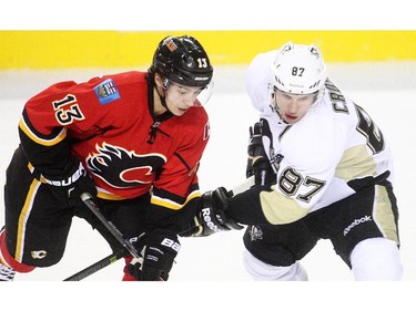 Pittsburgh Penguins captain Sidney Crosby jostles with Johnny Gaudreau of the Calgary Flames during the first period at the Saddledome Friday February 6, 2015.