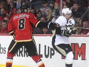 Joe Colborne of the Calgary Flames battles Sidney Crosby of the Pittsburgh Penguins on Friday. Colborne will be joined by his dad as the Flames take their fathers with them on a two-game California road trip.