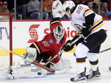 Calgary Flames goalie Karri Ramo stones winger David Pastmak of the of the Boston Bruins in close during the first period at the Saddledome Monday February 16, 2015.