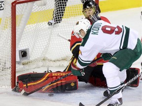 Calgary Flames goalie Jonas Hiller stops a shot from Minnesota Wild forward Mikko Koivu on Wednesday.
