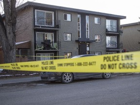 Police tape off an area around the scene of a shooting late Sunday evening just off 17th Avenue S.W. at 28th Street in Calgary, on February 23, 2015.
