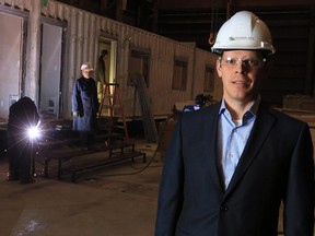 Joe Kiss, president of Ladacor Ltd., stands in his company's manufacturing facility in Calgary on Thursday February 12, 2015. Ladacor uses shipping containers to build a variety of modular buildings including a hotel in Ontario.